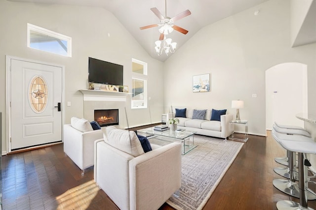 11707 Finnick Bend Dr, Tomball, TX 77377 - living room featuring a fireplace, dark wood-style flooring, arched walkways, ceiling fan, and high vaulted ceiling