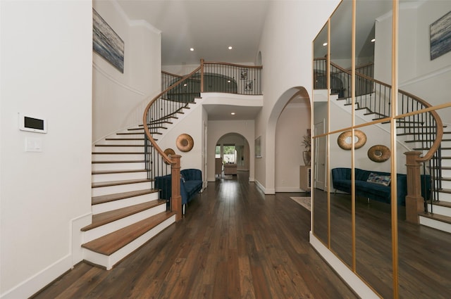 5502 Charlton Ridge Ln, Fulshear, TX 77441 - foyer entrance with stairway, arched walkways, a high ceiling, wood finished floors, and baseboards