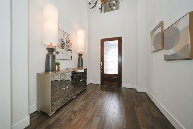 5502 Charlton Ridge Ln, Fulshear, TX 77441 - entrance foyer featuring a chandelier, dark wood-style flooring, baseboards, a towering ceiling, and arched walkways