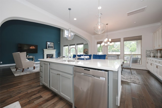 5502 Charlton Ridge Ln, Fulshear, TX 77441 - kitchen featuring stainless steel dishwasher, a sink, arched walkways, a chandelier, and a kitchen island with sink