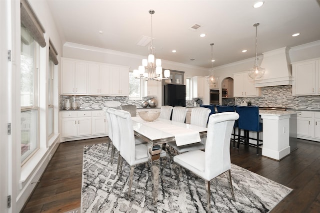5502 Charlton Ridge Ln, Fulshear, TX 77441 - dining area featuring arched walkways, a chandelier, crown molding, dark wood-style floors, and recessed lighting