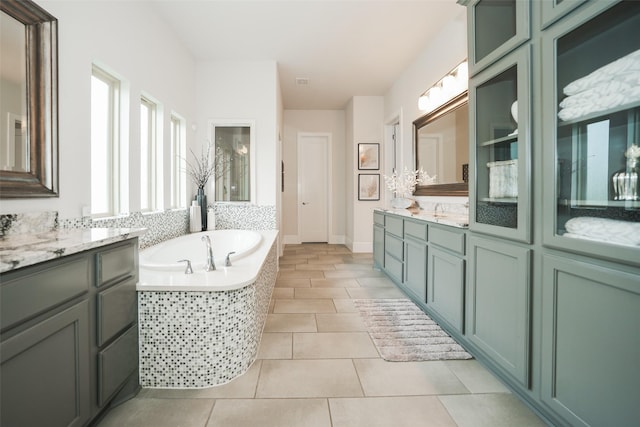 5502 Charlton Ridge Ln, Fulshear, TX 77441 - full bathroom with a garden tub, tile patterned flooring, two vanities, and baseboards