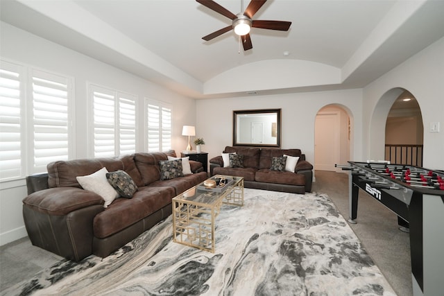 5502 Charlton Ridge Ln, Fulshear, TX 77441 - carpeted living room featuring lofted ceiling, arched walkways, ceiling fan, and baseboards