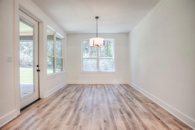 1973 Greentree Dr, Huntsville, TX 77340 - unfurnished dining area with a chandelier, light wood-style flooring, and plenty of natural light