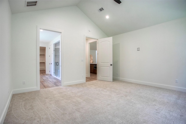 1973 Greentree Dr, Huntsville, TX 77340 - unfurnished bedroom with light carpet, a walk in closet, high vaulted ceiling, and connected bathroom