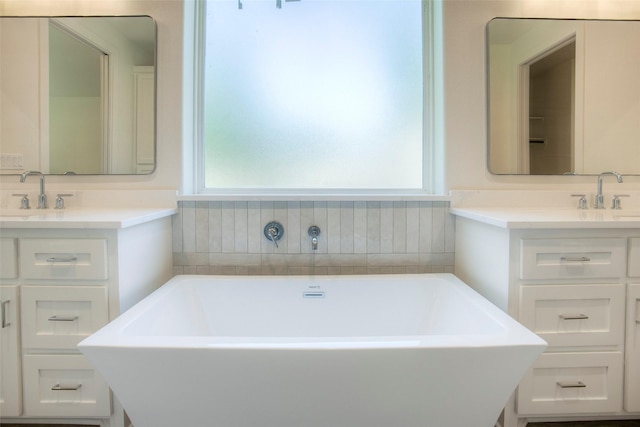 1973 Greentree Dr, Huntsville, TX 77340 - bathroom featuring healthy amount of natural light, a freestanding bath, and vanity