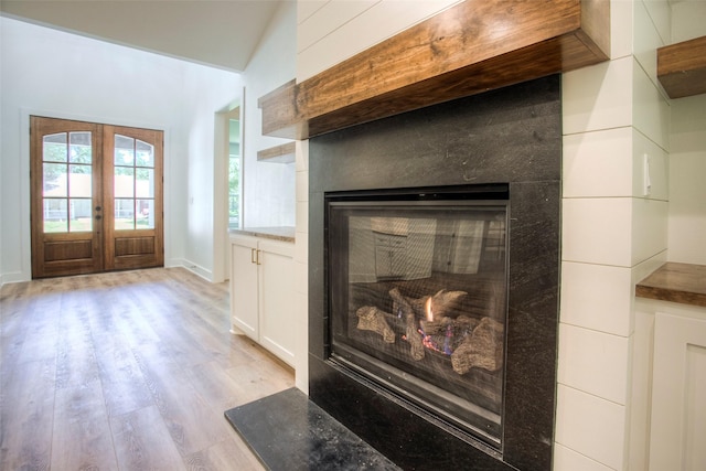 1973 Greentree Dr, Huntsville, TX 77340 - detailed view of a glass covered fireplace, wood finished floors, and french doors