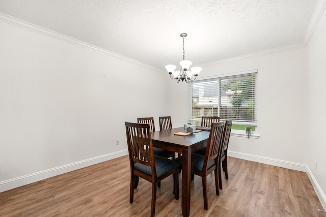 12114 Paddock Way, Houston, TX 77065 - dining area with a chandelier, wood finished floors, crown molding, baseboards, and a textured ceiling