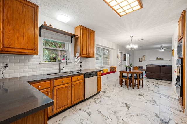 12114 Paddock Way, Houston, TX 77065 - kitchen featuring appliances with stainless steel finishes, a sink, dark countertops, backsplash, and a chandelier