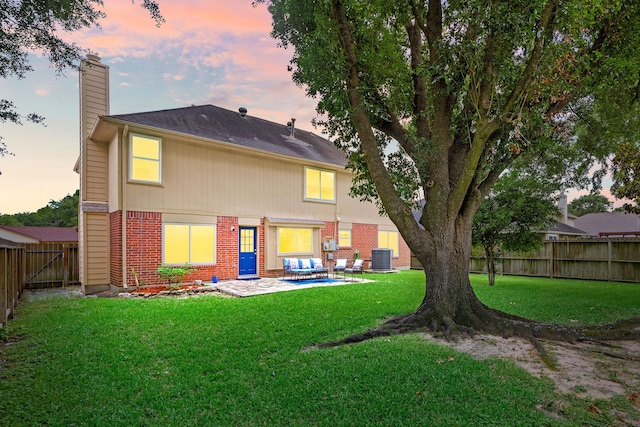 12114 Paddock Way, Houston, TX 77065 - back of property with brick siding, a chimney, a patio, and central air condition unit