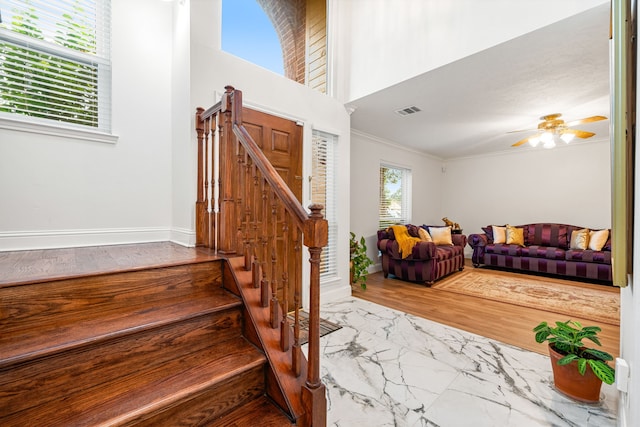 12114 Paddock Way, Houston, TX 77065 - stairway featuring ornamental molding, ceiling fan, baseboards, and marble look tile flooring