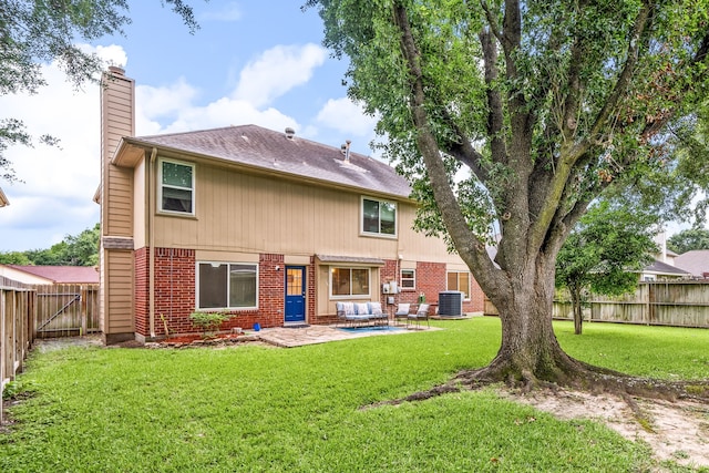 12114 Paddock Way, Houston, TX 77065 - back of property with a chimney, central AC, brick siding, a patio area, and a shingled roof
