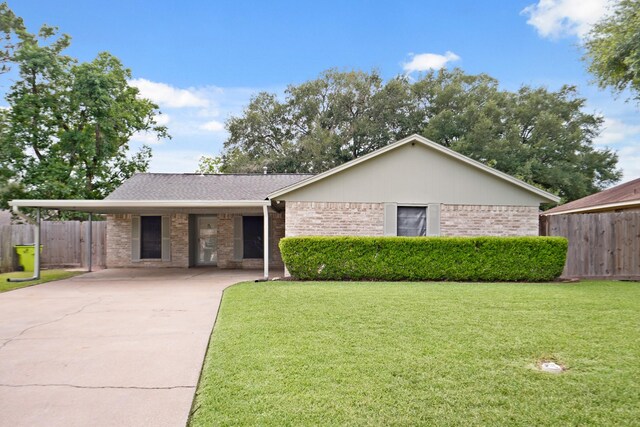 1926 Klauke Ct, Rosenberg, TX 77471 - view of front facade with brick siding, driveway, and a carport