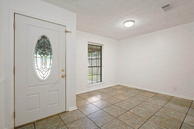 1926 Klauke Ct, Rosenberg, TX 77471 - tiled entrance foyer featuring a textured ceiling and baseboards