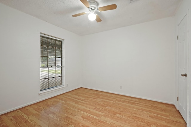 1926 Klauke Ct, Rosenberg, TX 77471 - empty room with light wood-style floors, ceiling fan, baseboards, and a textured ceiling