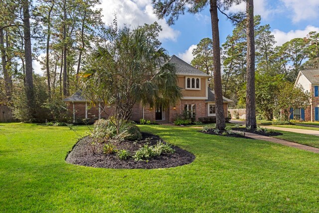 6131 Knollview Dr, Spring, TX 77389 - view of front facade featuring a front lawn and brick siding