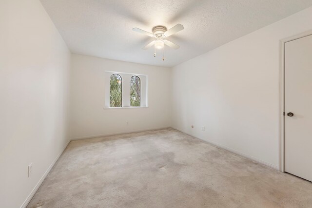 6131 Knollview Dr, Spring, TX 77389 - empty room featuring ceiling fan, light carpet, baseboards, and a textured ceiling