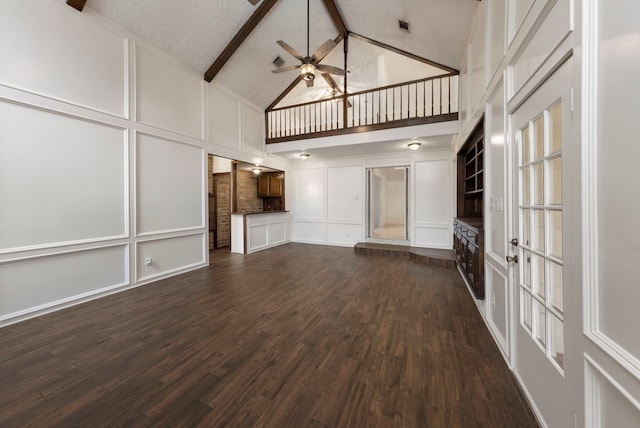 6131 Knollview Dr, Spring, TX 77389 - unfurnished living room featuring a decorative wall, high vaulted ceiling, ceiling fan, beam ceiling, and dark wood-type flooring