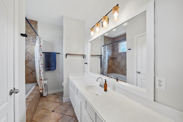 bathroom featuring tiled shower / bath combo, vanity, baseboards, and toilet