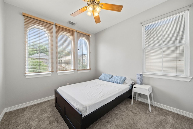 carpeted bedroom featuring baseboards and ceiling fan