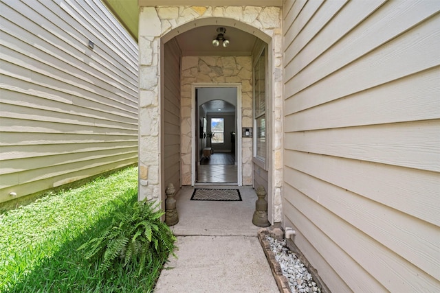 property entrance with stone siding