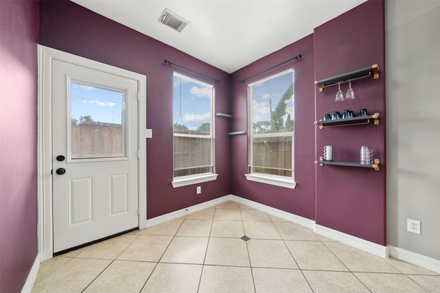 entryway featuring light tile patterned floors and baseboards