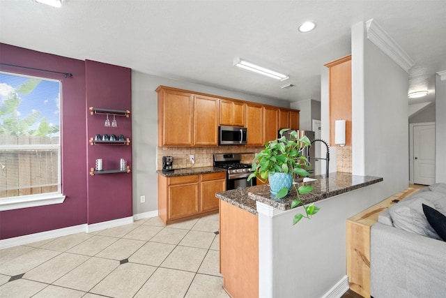 kitchen featuring appliances with stainless steel finishes, backsplash, a peninsula, dark stone countertops, and recessed lighting