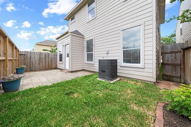rear view of property featuring central air condition unit and a patio