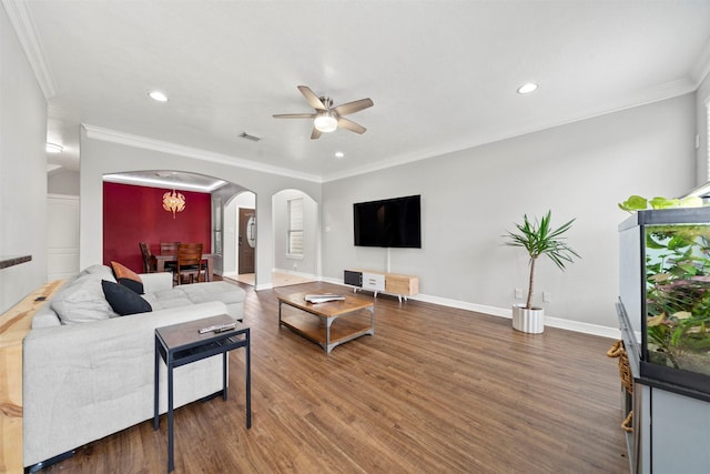living room with arched walkways, a ceiling fan, recessed lighting, wood finished floors, and ornamental molding