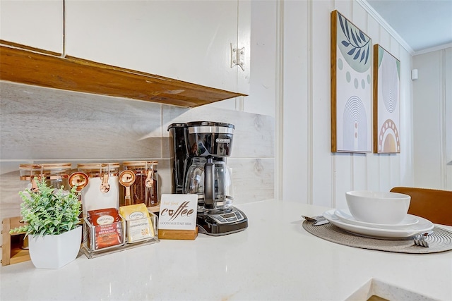 kitchen view of ornamental molding and light countertops