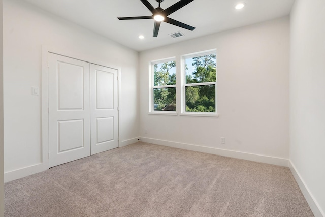 unfurnished bedroom featuring carpet flooring, recessed lighting, baseboards, a closet, and a ceiling fan