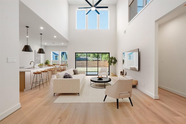 1420 Flamingo St, Conroe, TX 77385 - living area featuring a high ceiling, light wood-style floors, baseboards, and recessed lighting