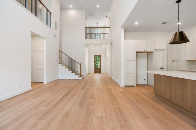 1420 Flamingo St, Conroe, TX 77385 - entrance foyer featuring light wood-style flooring, stairway, a towering ceiling, baseboards, and recessed lighting