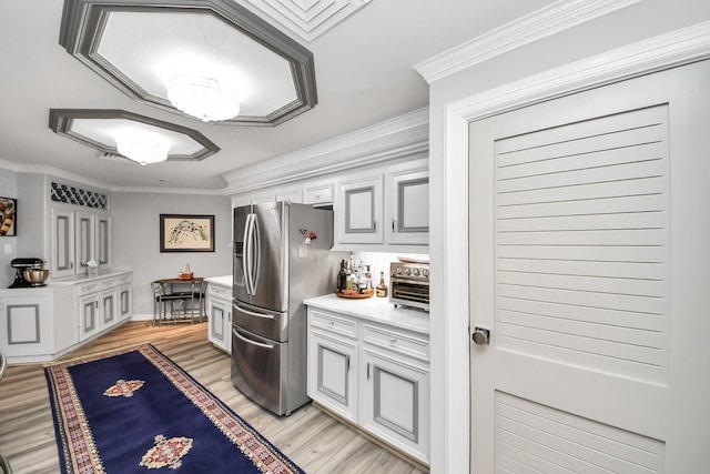 5050 Woodway Dr Unit 7L, Houston, TX 77056 - kitchen with stainless steel fridge with ice dispenser, light wood-style flooring, light countertops, ornamental molding, and white cabinetry