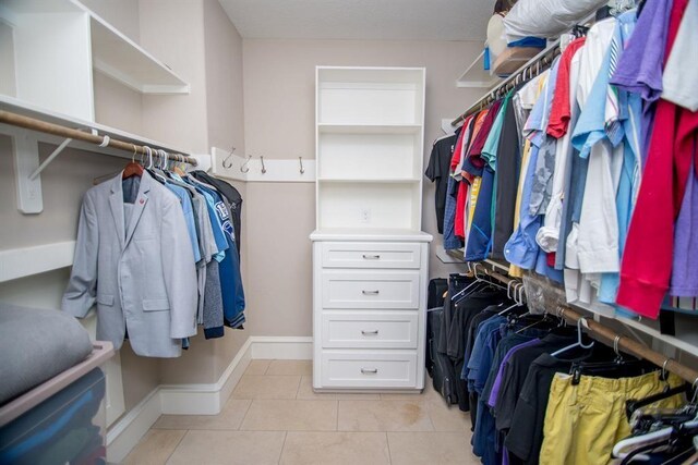 14115 Woodthorpe Ln, Houston, TX 77079 - walk in closet with light tile patterned flooring