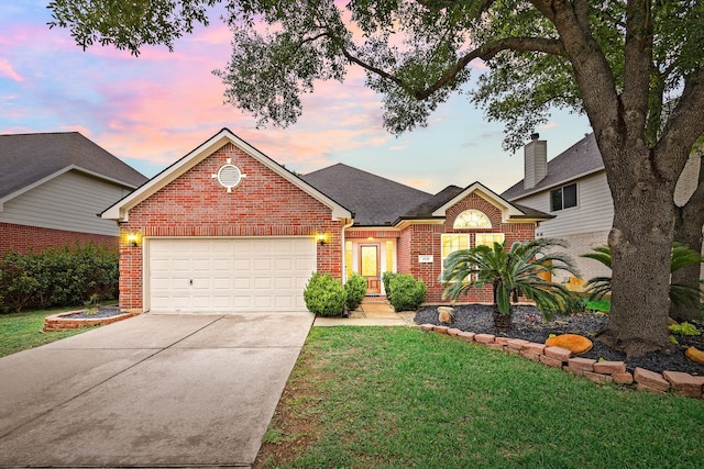 traditional-style house with brick siding, driveway, a garage, and a front lawn