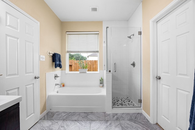 full bathroom with a shower stall, a bath, baseboards, and vanity