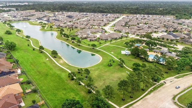 aerial view of property and surrounding area featuring nearby suburban area and a nearby body of water