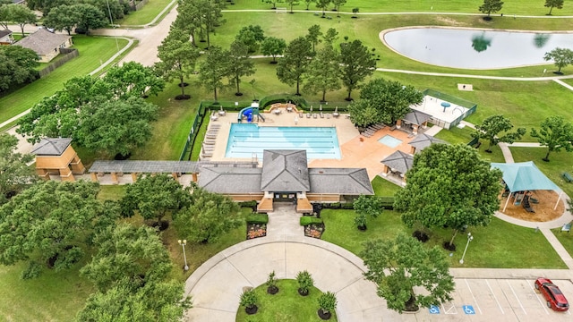 drone / aerial view of a large body of water and a pool