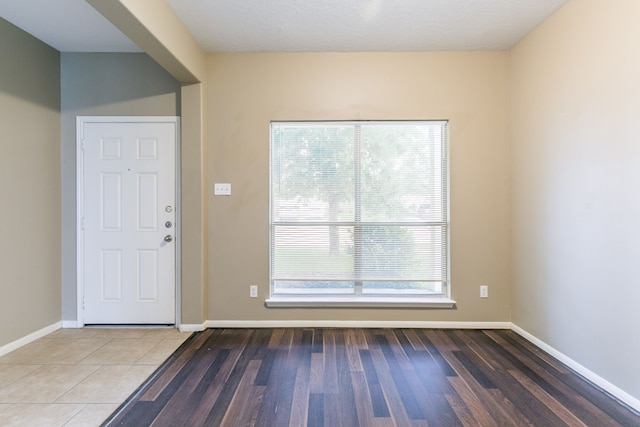 entrance foyer featuring baseboards and wood finished floors