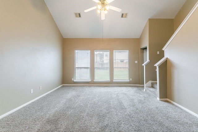unfurnished living room with a ceiling fan, carpet floors, stairs, baseboards, and high vaulted ceiling