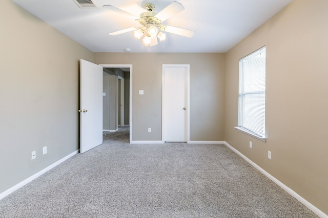 unfurnished bedroom with carpet floors, baseboards, and a ceiling fan