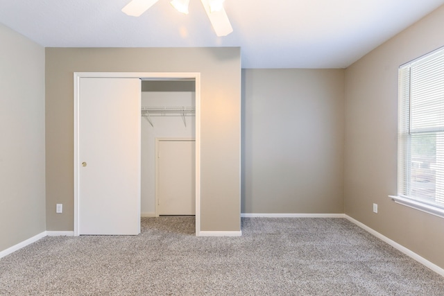 unfurnished bedroom with carpet flooring, a closet, ceiling fan, and baseboards