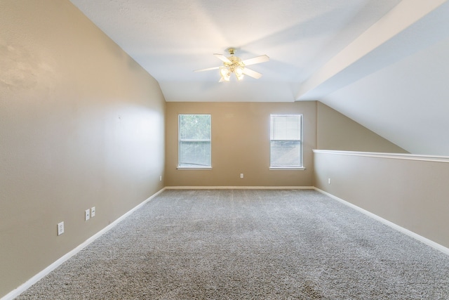 bonus room featuring lofted ceiling, ceiling fan, carpet flooring, and baseboards