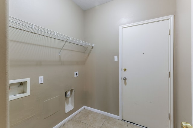 washroom featuring hookup for an electric dryer, washer hookup, light tile patterned floors, and baseboards