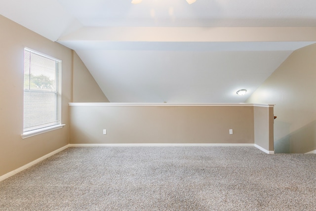 additional living space featuring vaulted ceiling, carpet floors, a ceiling fan, and baseboards