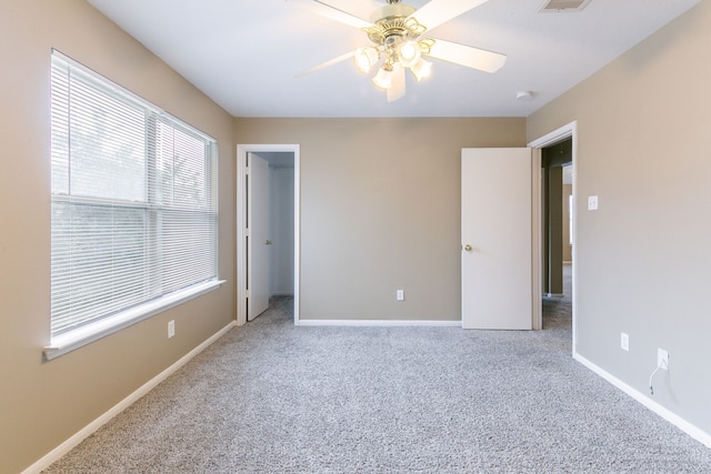 unfurnished bedroom with carpet floors, baseboards, and a ceiling fan