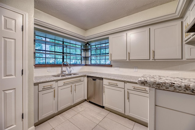 4650 Hickory Downs Dr, Houston, TX 77084 - kitchen featuring dishwasher, a sink, a textured ceiling, light tile patterned floors, and backsplash
