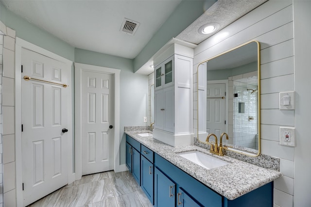 4650 Hickory Downs Dr, Houston, TX 77084 - full bath featuring marble look tiles, double vanity, tiled shower, and baseboards