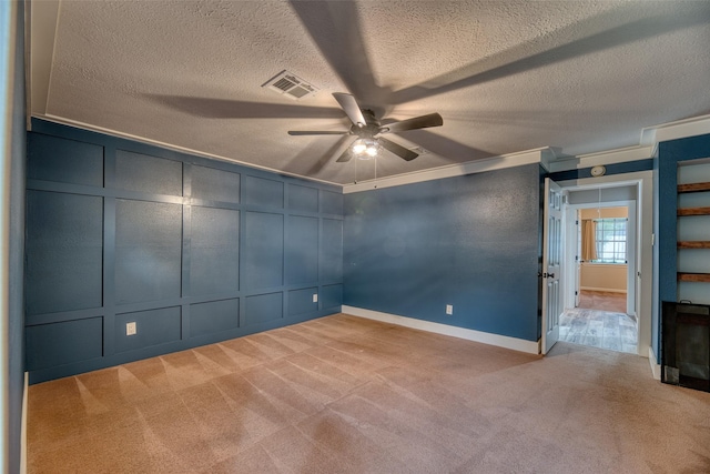 4650 Hickory Downs Dr, Houston, TX 77084 - unfurnished bedroom featuring carpet flooring, a decorative wall, a textured ceiling, baseboards, and a ceiling fan